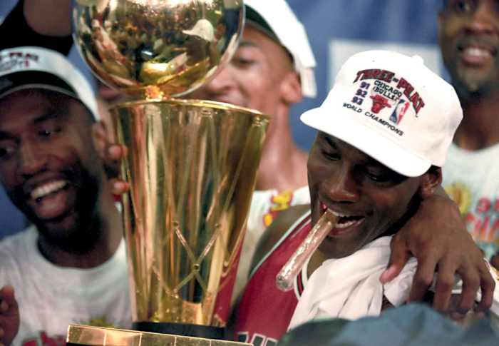 Jun 1993; Phoenix, AZ, USA; FILE PHOTO; Chicago Bulls guard Michael Jordan (right) celebrates with the championship trophy following the Bulls defeating the Phoenix Suns in the 1993 NBA Finals at America West Arena.